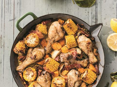 Ovenschotel met drumsticks, maïs, zoete aardappel en spek