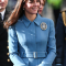 In een blauwe jas van Alexander McQueen met hoed van Lock & Co