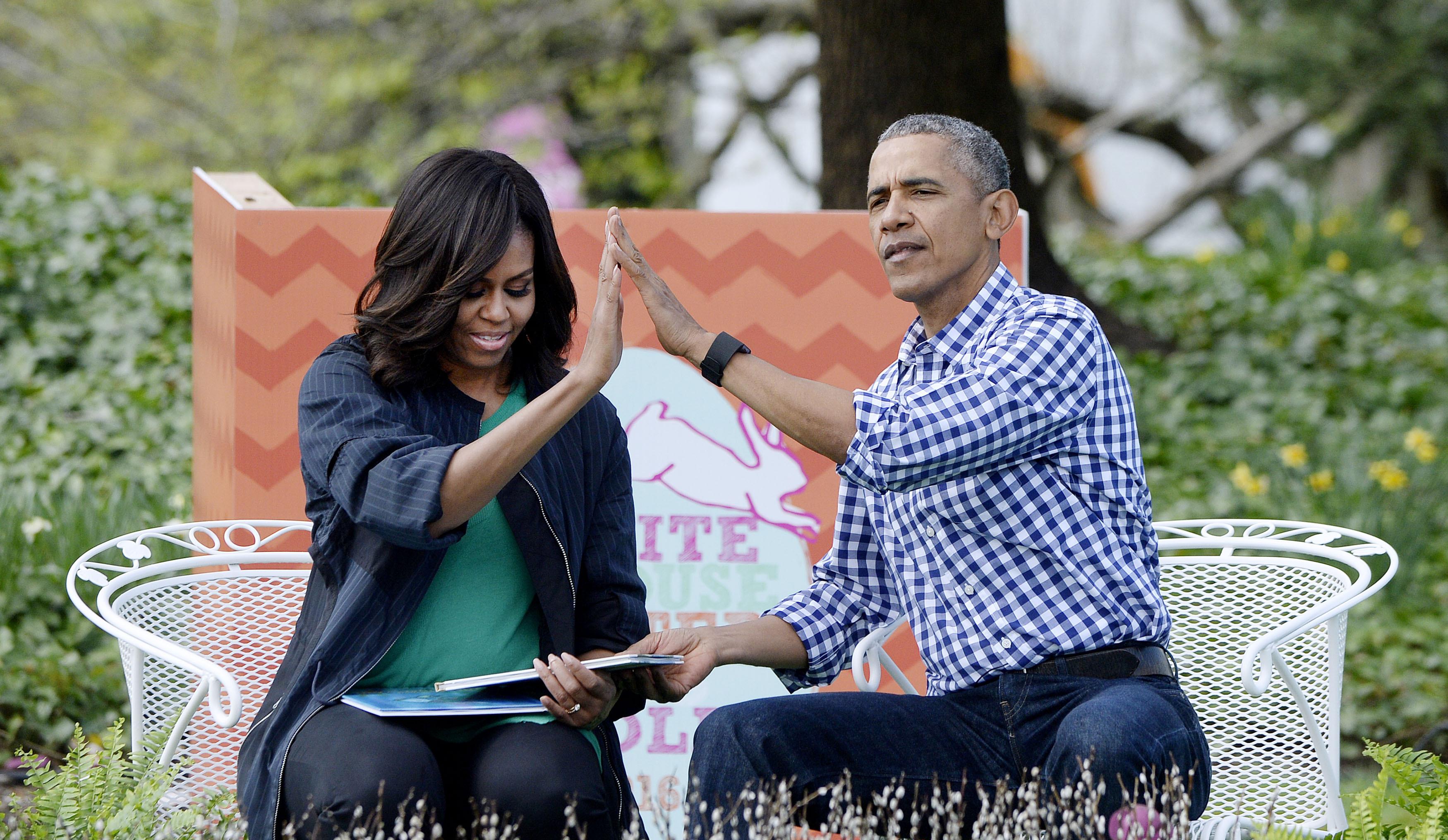 United States President Barack Obama (R) and first lady Michelle Obama (L) read "Where the wild things are"during the White House Easter Egg Roll on the South Lawn of the White House March 28, 2016 in Washington, DC.  Reporters / Photoshot