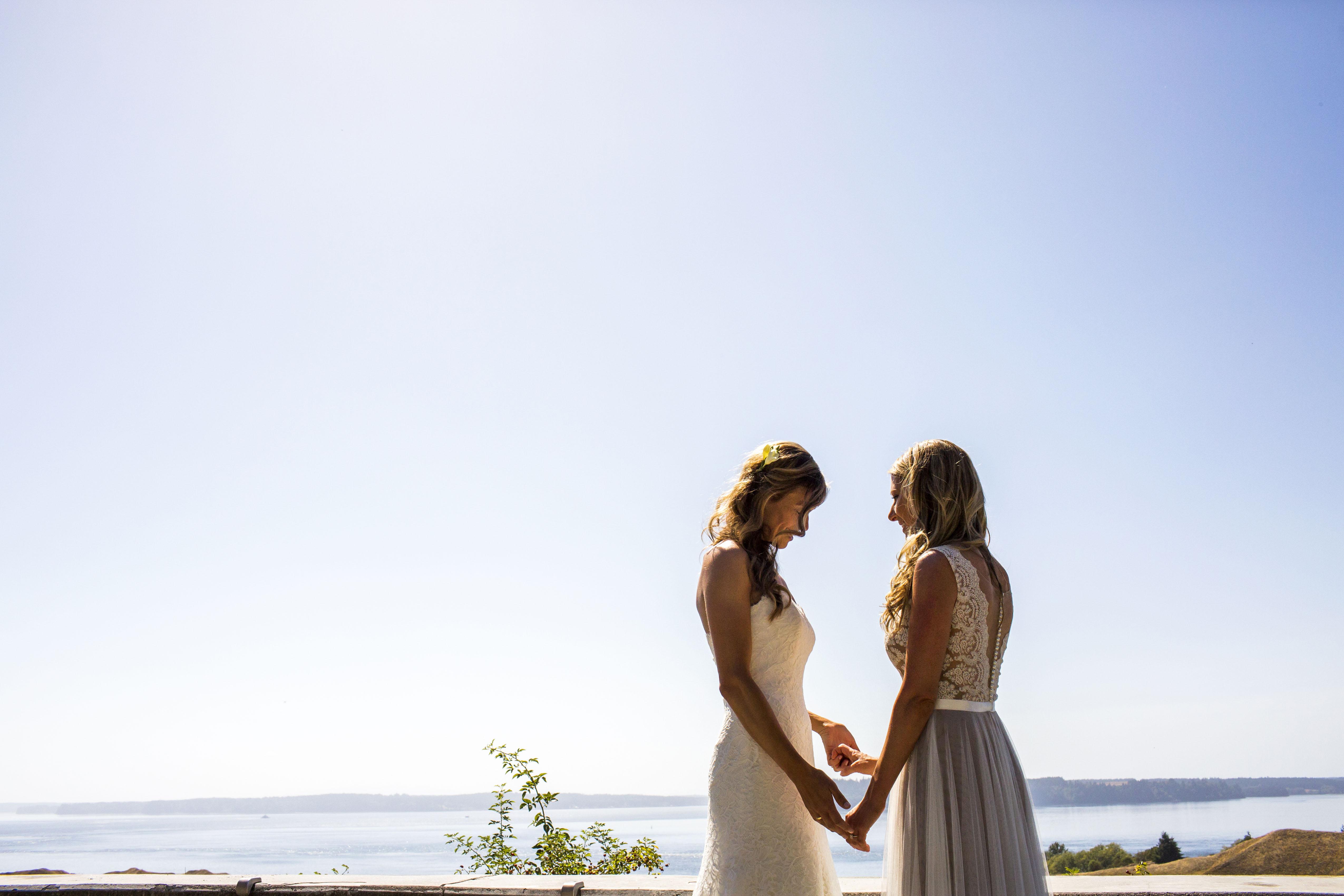 Lesbian Couple Kissing In Tent At Beach During Sunset Fashionista