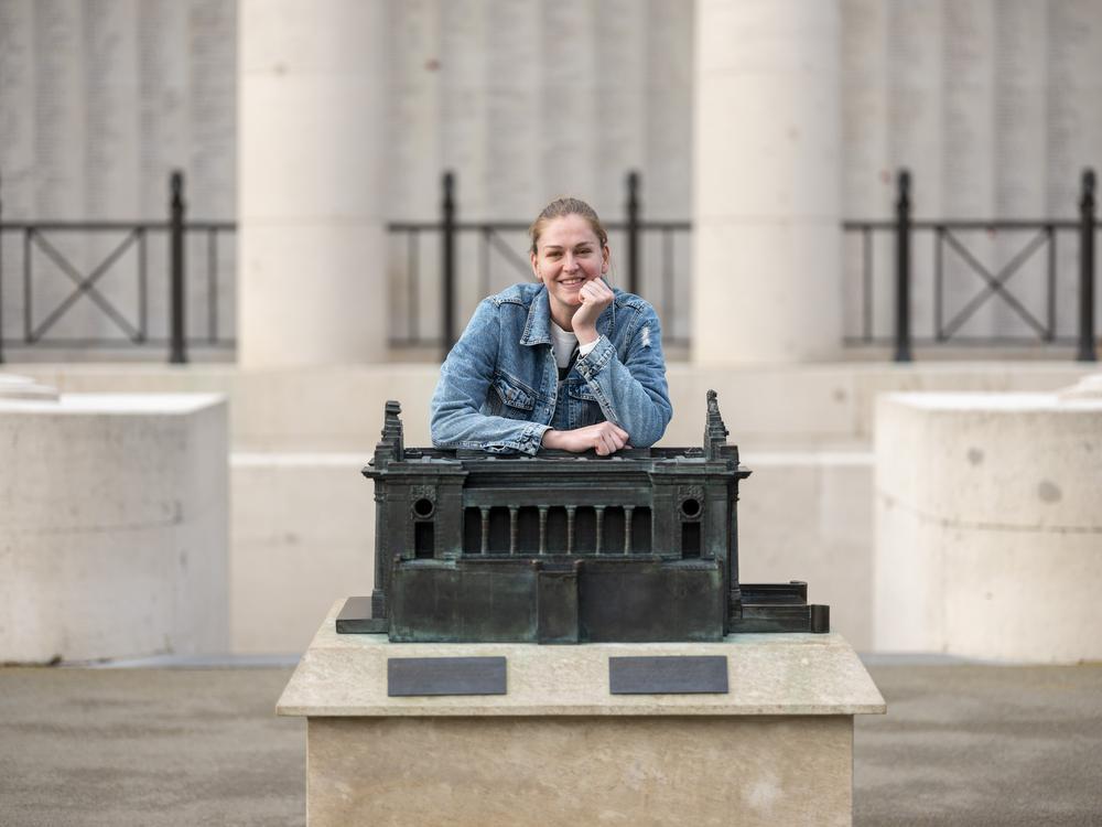 Emma Meesseman boven op de Menenpoort bij een miniatuurversie van het monument: 