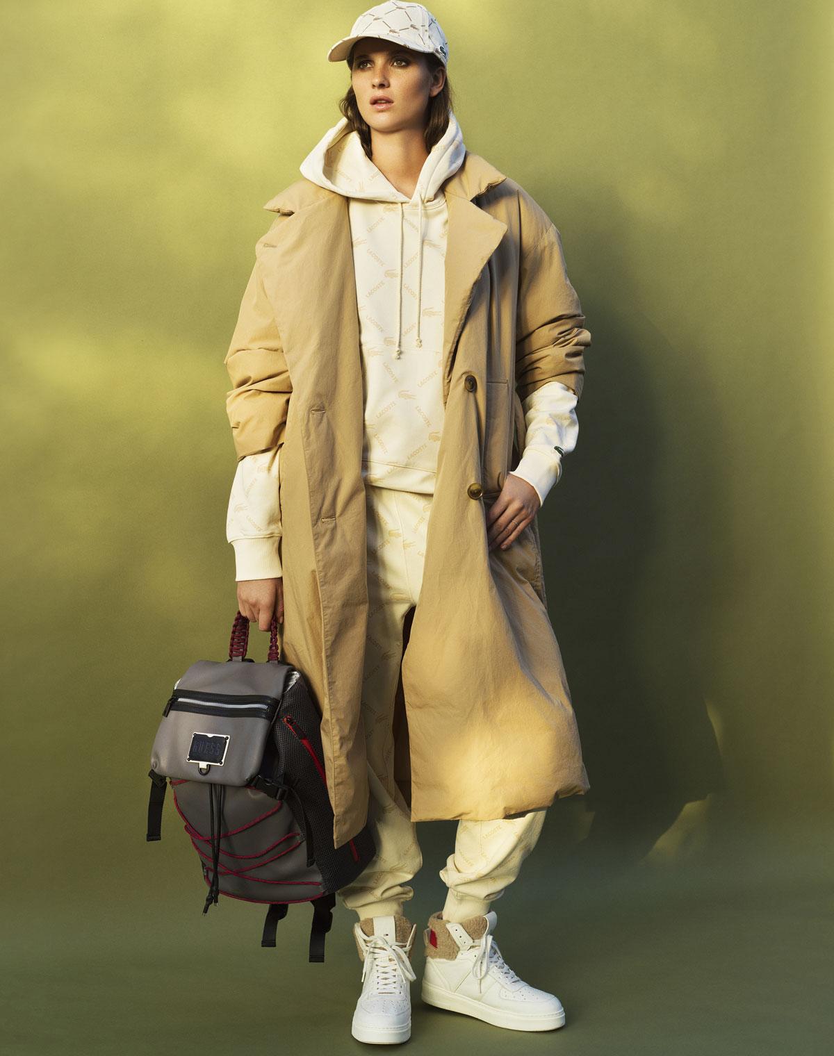 Puffer trench (Uniqlo, € 129,90). Sweater (Lacoste, € 130). Joggingbroek (Lacoste, € 160). Pet (Lacoste, € 70). Baskets (Tommy Hilfiger, € 159,90). Rugzak (Guess, € 125).