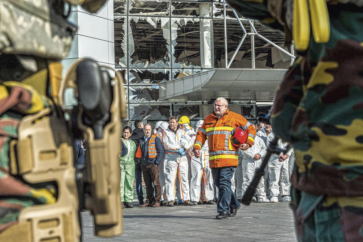 Een dag na de aanslagen brengen medewerkers van Brussels Airport en hulpverleners een eerbetoon aan de slachtoffers.