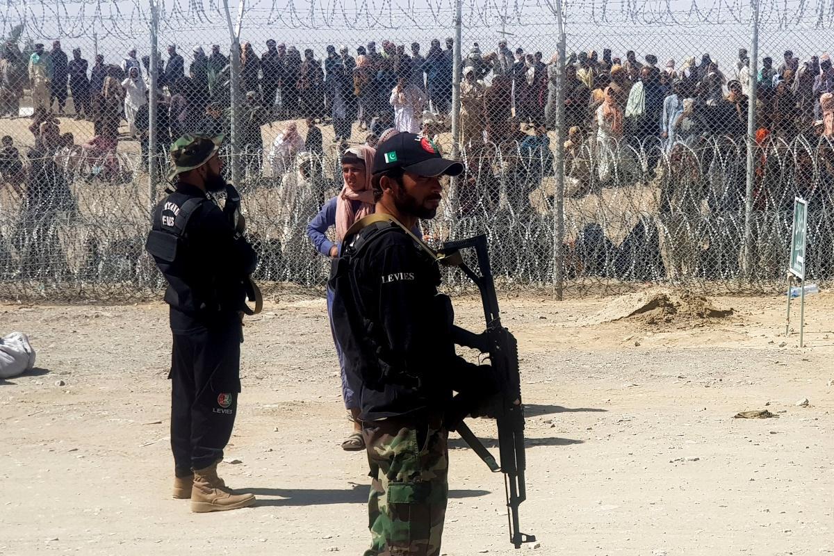 Afghanen wachten om de grens met Pakistan over te steken. 