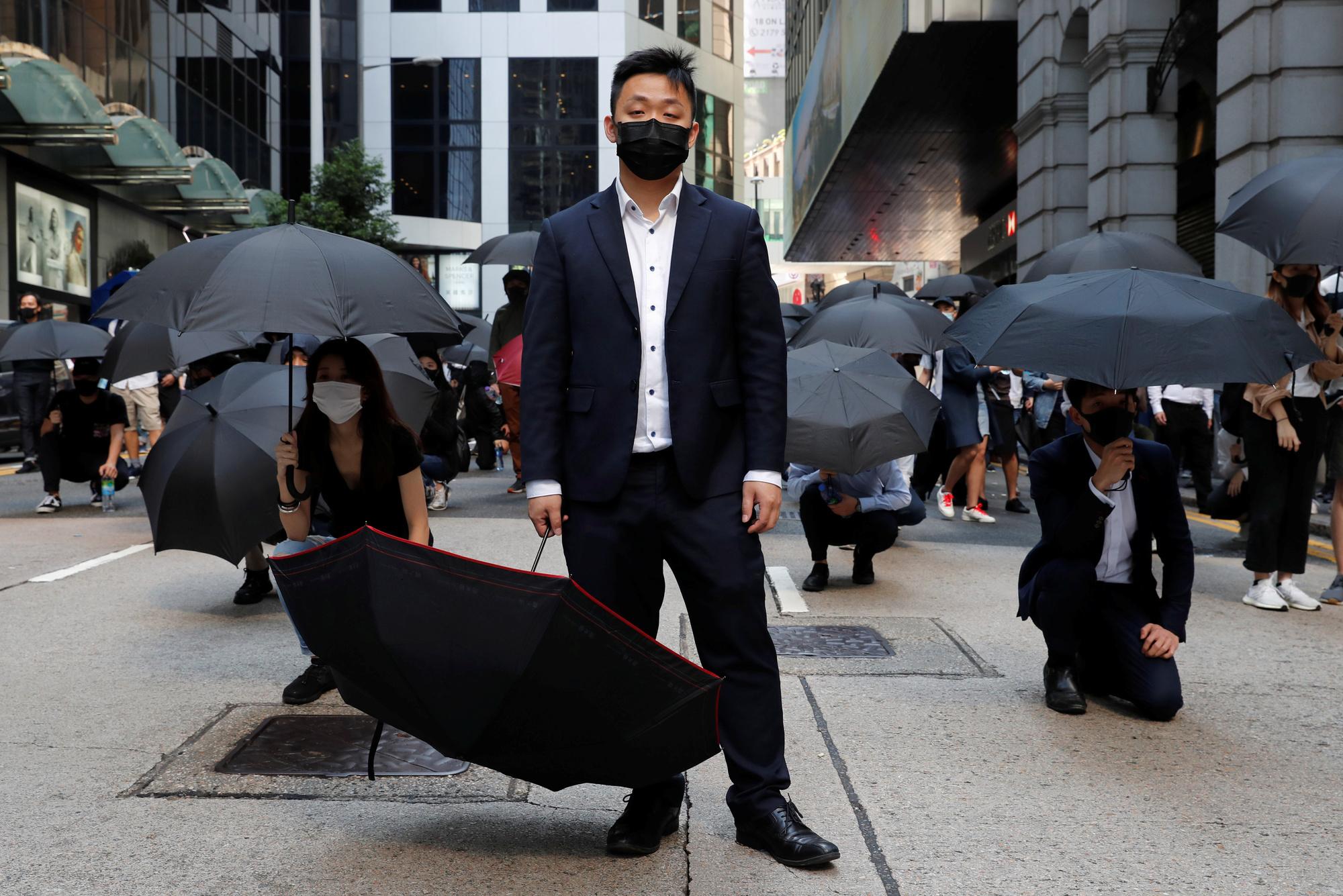 Mensen protesteren met paraplu's om zich te beschermen tegen het traangas van de oproerpolitie in Hongkong.
