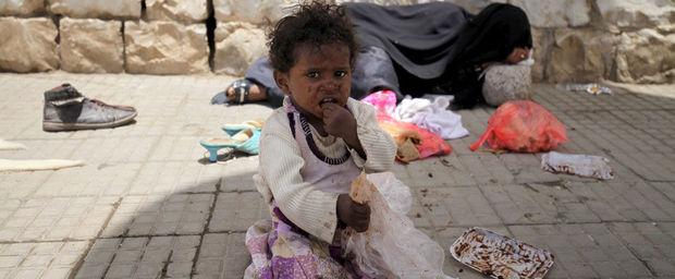 Een meisje zit op straat met haar slapende moeder in de Jemenitische hoofdstad Sanaa. De humanitaire crisis is geëscaleerd door de oorlog van de Saudische coalitie tegen Houthi's in het land. 