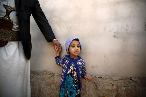 Een meisje aan de hand van haar vader nadat ze gevaccineerd werd voor polio. 