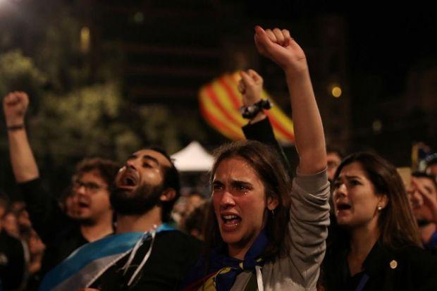 Catalanen luisteren naar een toespraak van hun president Carles Puigdemont op zondagavond 1 oktober. 