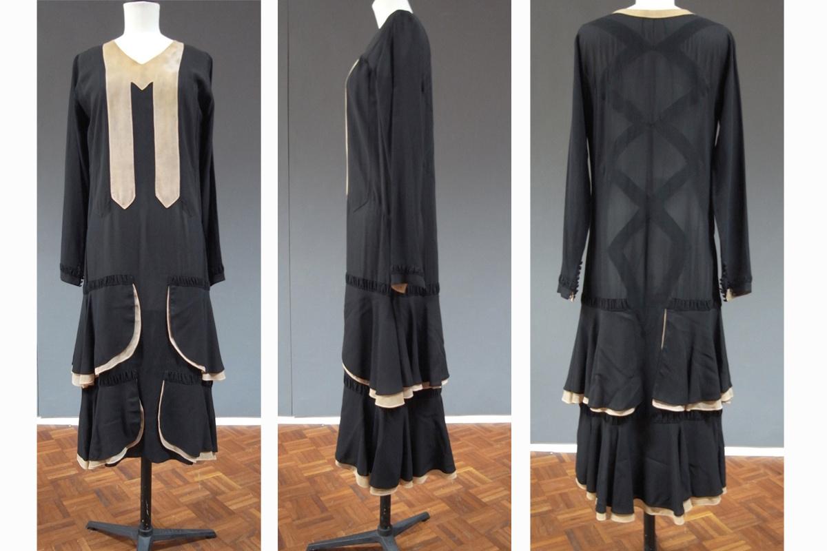 Onder meer deze zwarte zijden jurk uit ca. eind jaren '20 wordt bewaard in het MoMu. Het strakke ruitenmotief op de rug vormt een spies doorheen de fronsen en ruches.