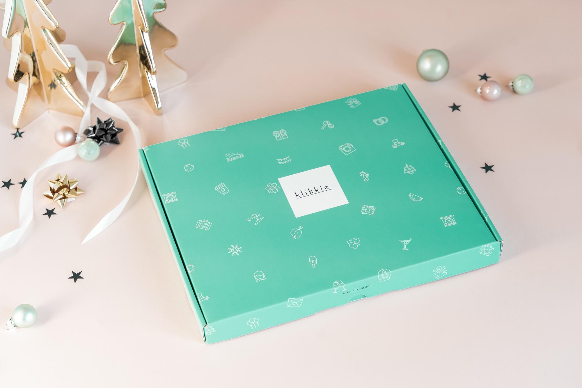 In de geschenkverpakking: een printabonnement, een fotoboek, dubbelzijdige plakkers en een stiftje om wat moois bij je foto's te schrijven.