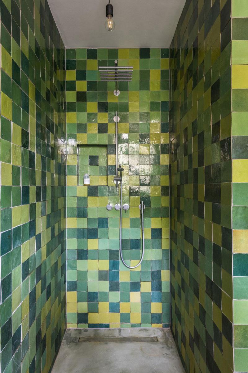 Ook in de badkamer komen de seventies terug. De inloopdouche kreeg een mozaïek van groene zellige tegels.