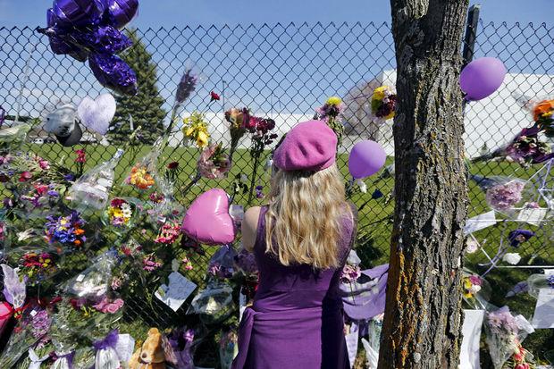 Une fan de Prince se recueille devant sa propriété de Paisley Park au lendemain de sa mort, le 22 avril 2016