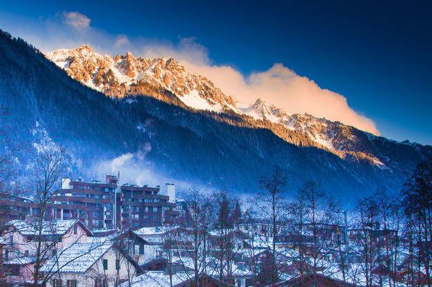 Mountains near chamonix before sunset lightened with sun rays, view of Southern part of town Chamonix, France in twilight