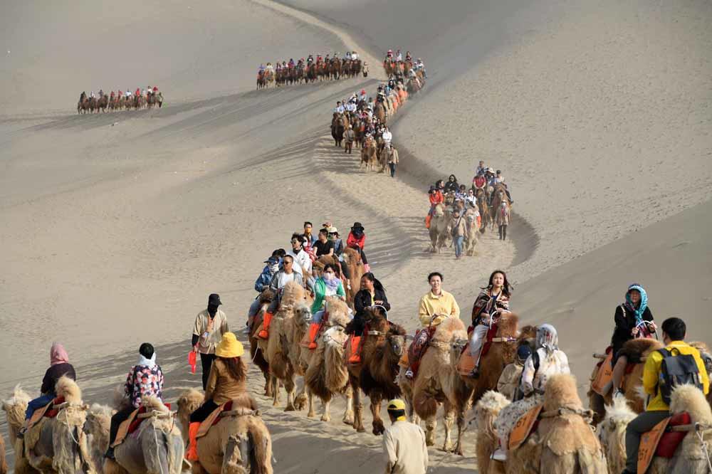 Route de la soie: ces touristes à l'assaut des dunes Dunhuang (en images)