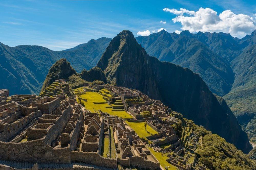 The majestic Machu Picchu during daytime with dry yellow grass in the sacred valley of the Inca, Peru.