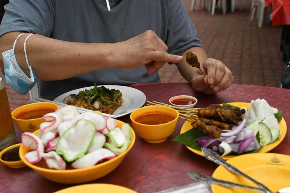 Les hawkers de Singapour: une gastronomie de rue qui risque de disparaître (en images)