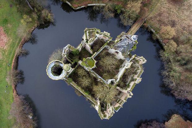 An aerial picture taken on January 23, 2018 shows the ruined castle of La Mothe-Chandeniers invaded by vegetation, in Les Trois-Moutiers, central western France. Specialized in the rescue of old stones, the crowdfunding site Dartagnans.fr and the association 