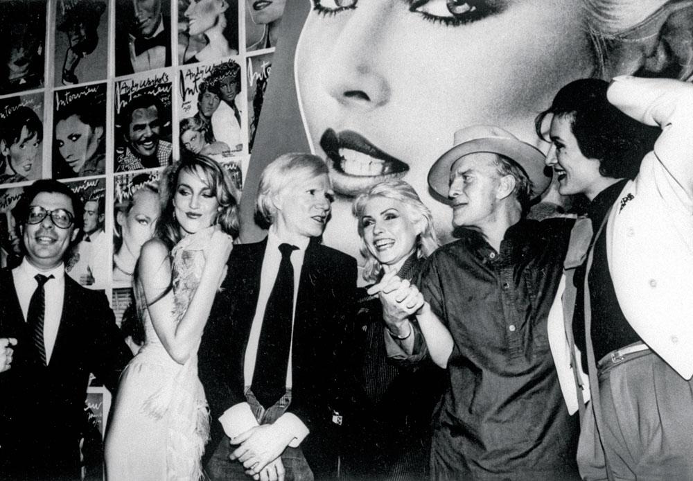 Een feestje voor Andy Warhols Interview-magazine in 1979, vlnr.: redacteur Bob Colacello, Jerry Hall  (de toekomstige mevrouw Mick Jagger), Andy Warhol, Blondie-zangeres Debby Harry, schrijver Truman Capote en Paloma Picasso (juwelenontwerpster en dochter van).