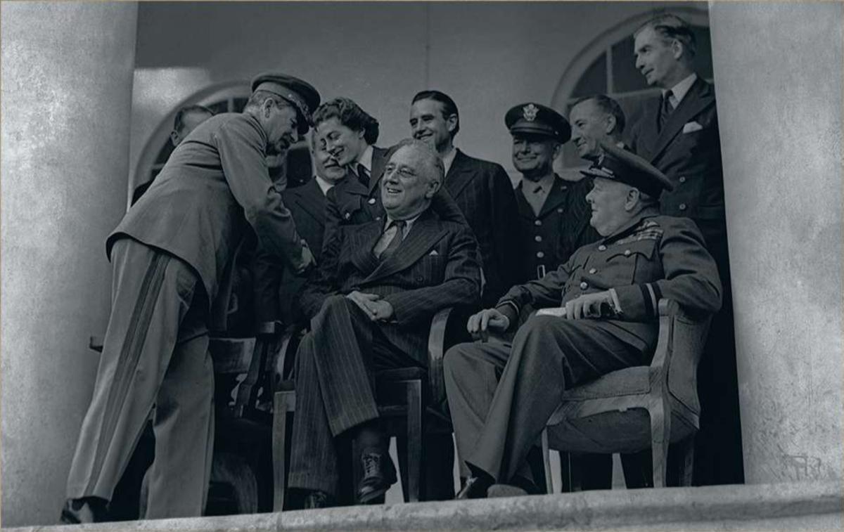 Lors de la conférence de Téhéran, le leader russe Joseph Staline serre la main de Sarah Churchill, fille du Premier ministre britannique, assis à côté du président Roosevelt (au milieu).