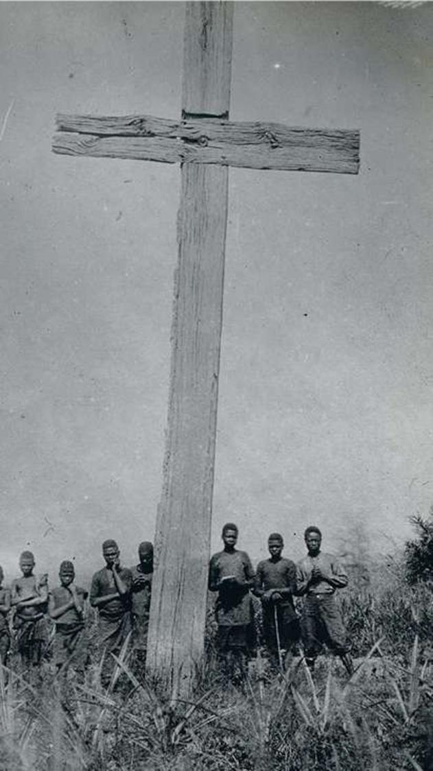 Propagation de la foi Des Kongos convertis au christianisme au pied d'une gigantesque croix en bois.