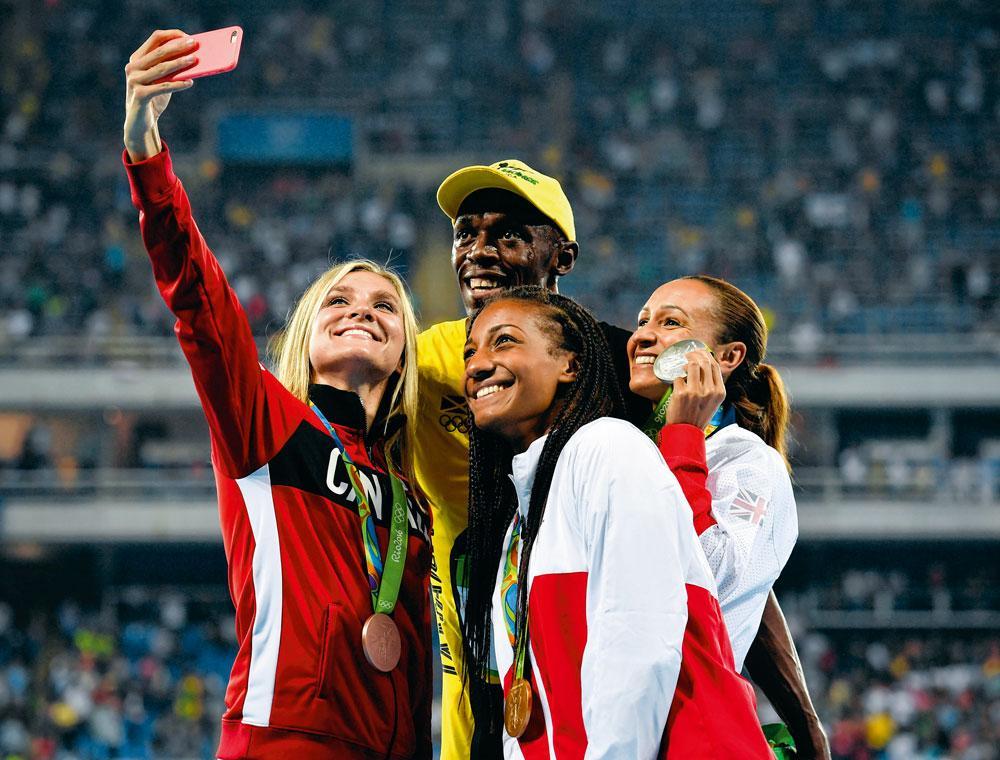 Nafi Thiam op het Olympisch podium. 'De beste selfie ooit', noemde ze de foto met Usain Bolt.