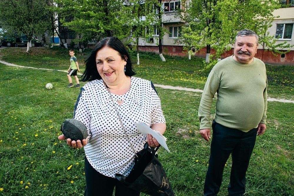 Ekaterina, de moeder van Roeslan, toont zijn eerste bal, gemaakt van kousen. Vader Vladimir kijkt toe.