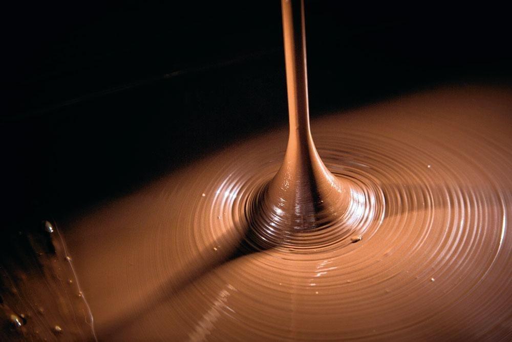 1. Le tempérage - Tout commence avec du chocolat. Chaud. Trop chaud d'ailleurs. Stocké dans des cuves à l'état liquide, il doit être d'abord refroidi. Une opération qui se fait progressivement, via le travail d'une tempéreuse qui amènera doucement le chocolat à 32 °C. L'opération prend une dizaine de minutes.