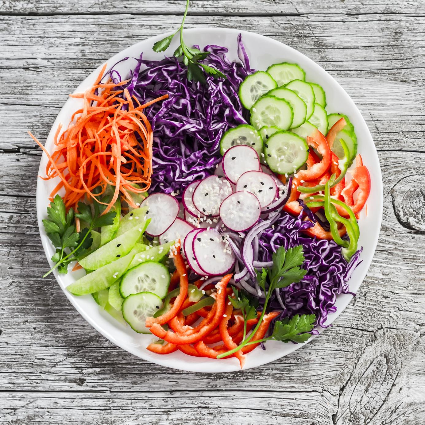 vegetable salad with red cabbage, cucumber, radish, carrots, sweet peppers