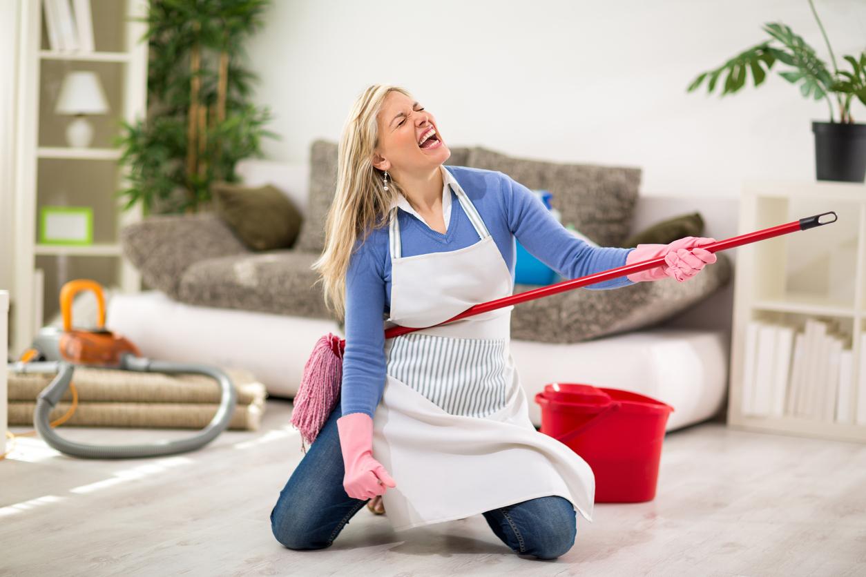 Funny female make joke while cleaning house