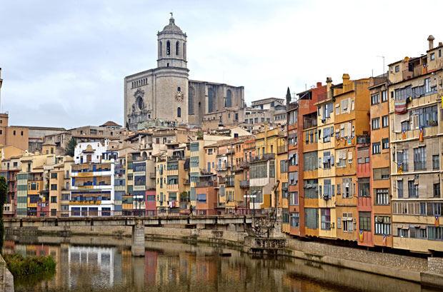 Het patchwork van hangende huizen en de kathedraal van Girona.