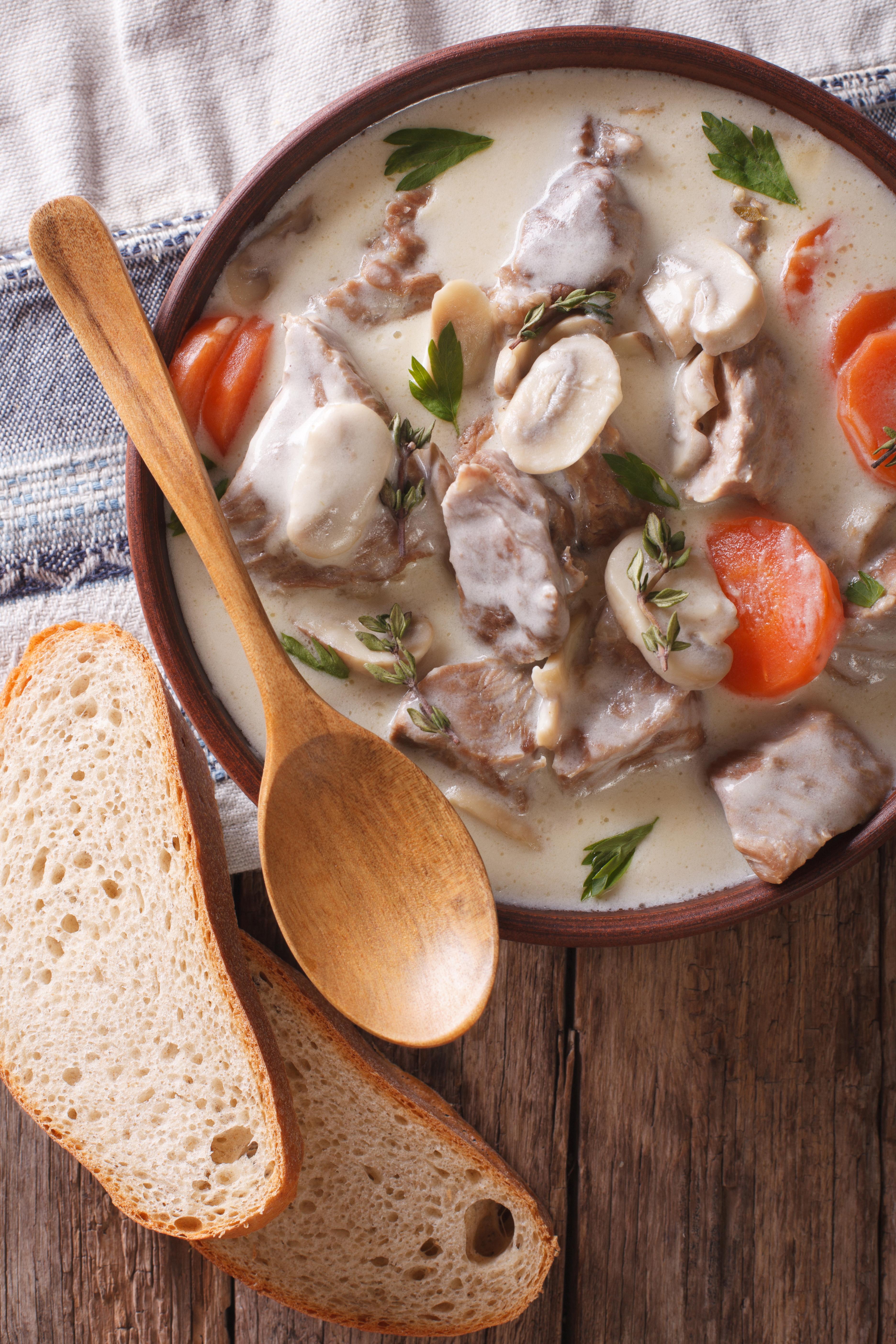 Blanquette of veal in a creamy sauce in a bowl on the table. vertical view from above