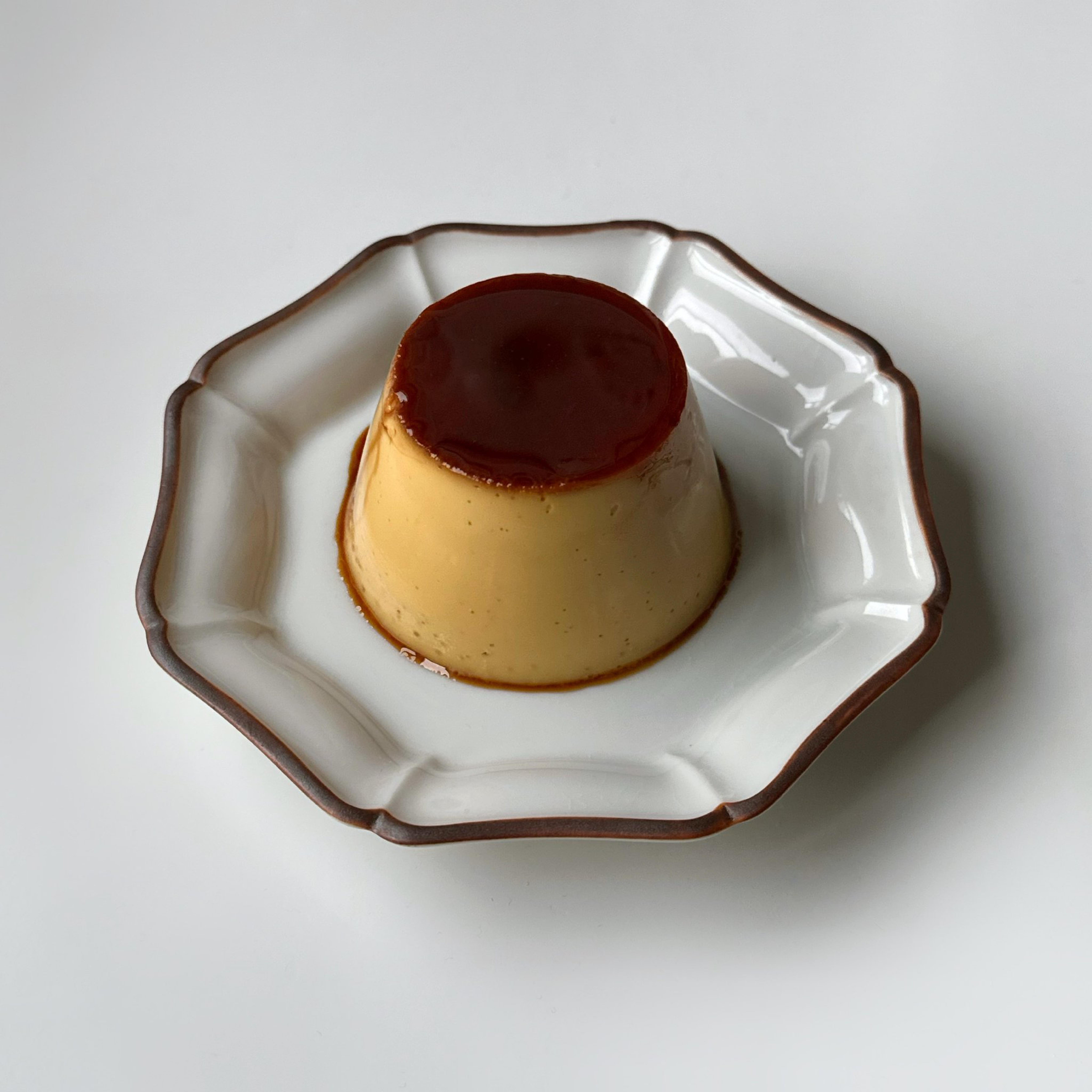 Italian dessert - panna cotta with berries and caramel sauce.