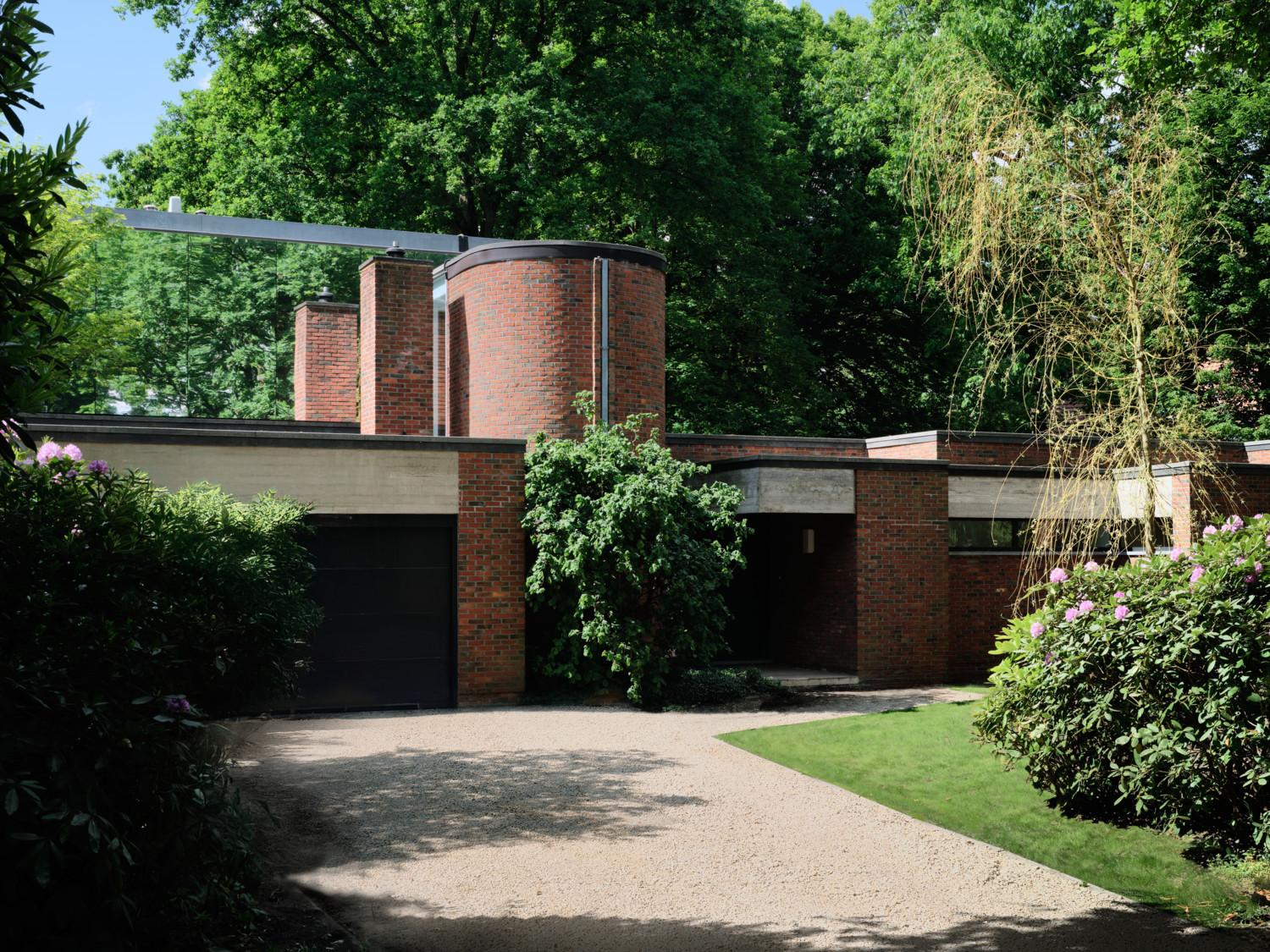 Spot de spiegelende extra laag op het huis.  De opvallende bakstenen koker huist de spiraaltrap die oud en nieuw met elkaar verbindt.