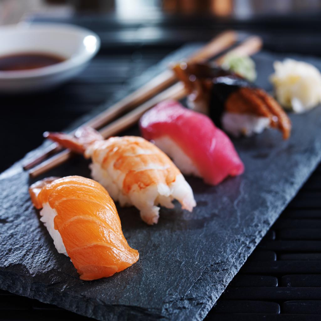 Close-up or assorted sushi nigiri on black slate