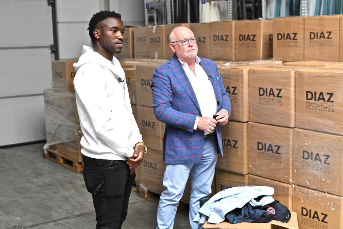 Fashion Sakala kreeg van KV Oostende-sponsor Diaz 3 ton kledij voor zijn geboorteland. Frank Dierckens van Diaz kijkt toe.©Maxime Petit