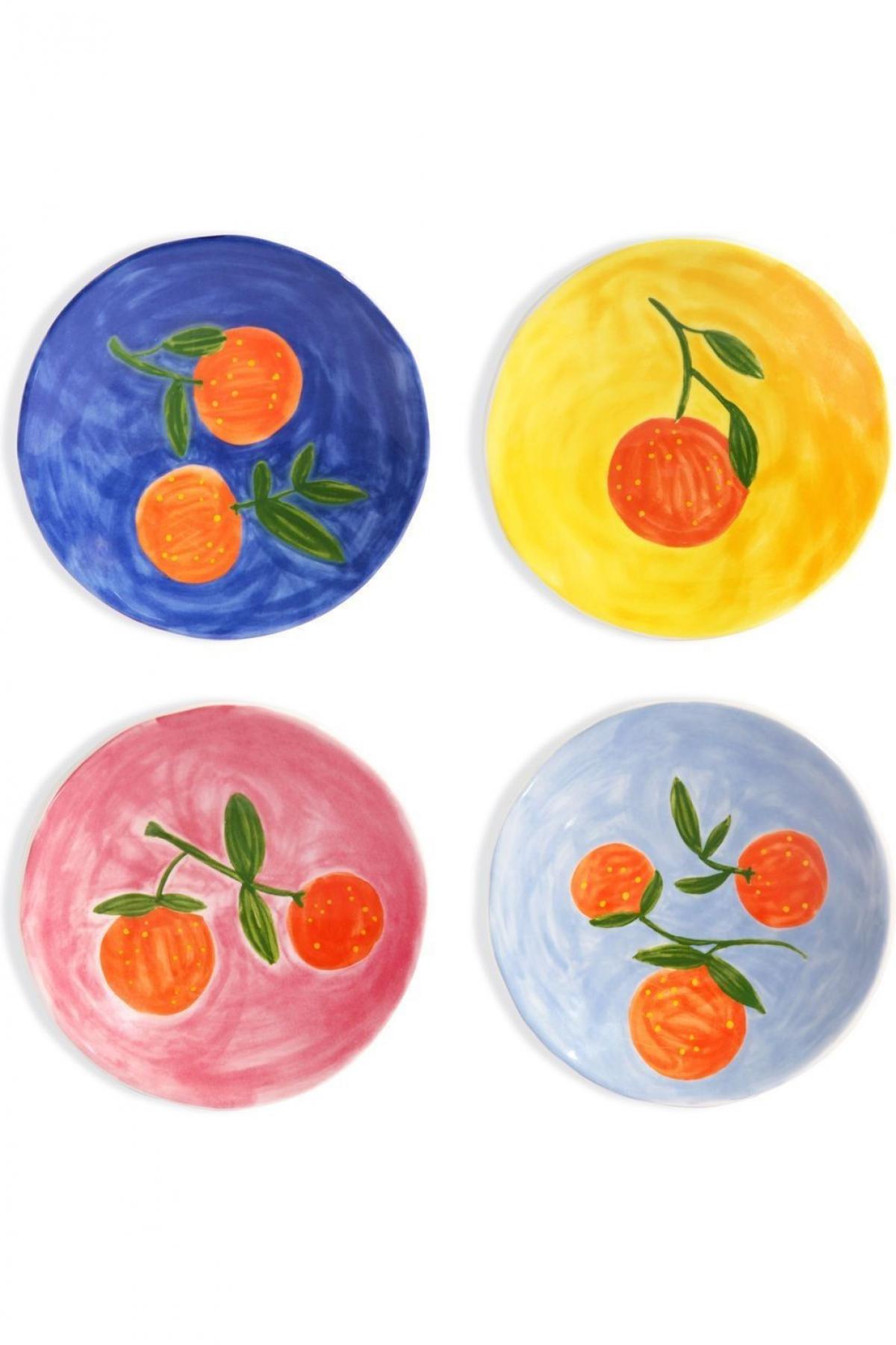 Geschilderde bordenset in primaire kleuren met fruit