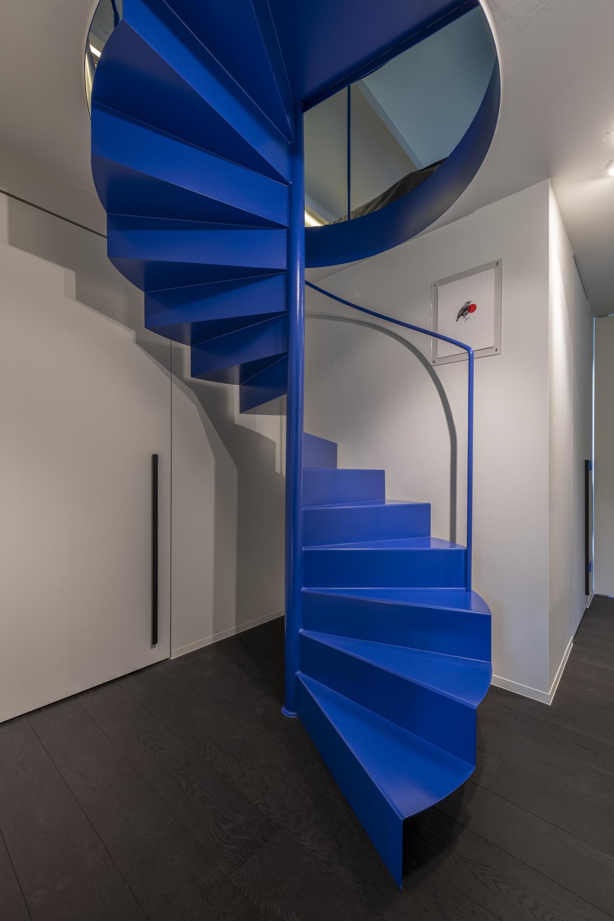 De typerende huiskleur Bleu Outremer herhaalt zich in de nachtzone met de wenteltrap, als wandkleur in de kinderkamer en in de originele Les Couleurs® Le Corbusier Jung-lichtschakelaars.© Pieter Clicteur