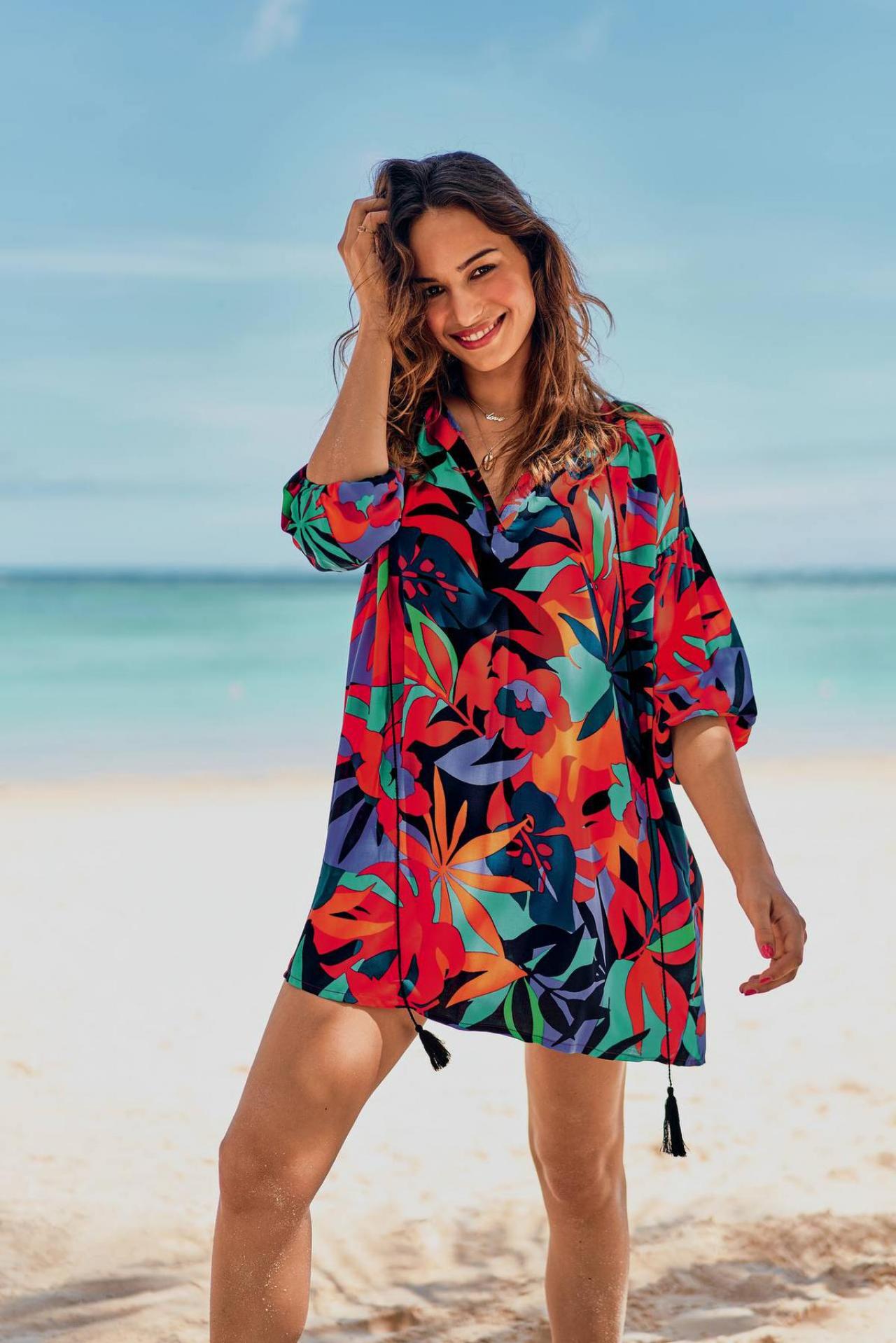 Ideaal voor de weg van en naar het strand: kleurig strandhemd/mini-jurk met exotisch bladmotief (79,95 euro), van Rosa Faia.© Rosa Faia