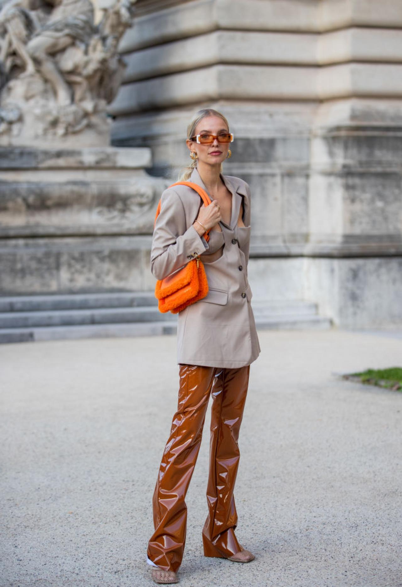 PARIS, FRANCE - SEPTEMBER 30: Leonie Hanne seen wearing ripped blazer, orange bag, brown pants outside rokh during Paris Fashion Week - Womenswear Spring Summer 2022 on September 30, 2021 in Paris, France. (Photo by Christian Vierig/Getty Images)