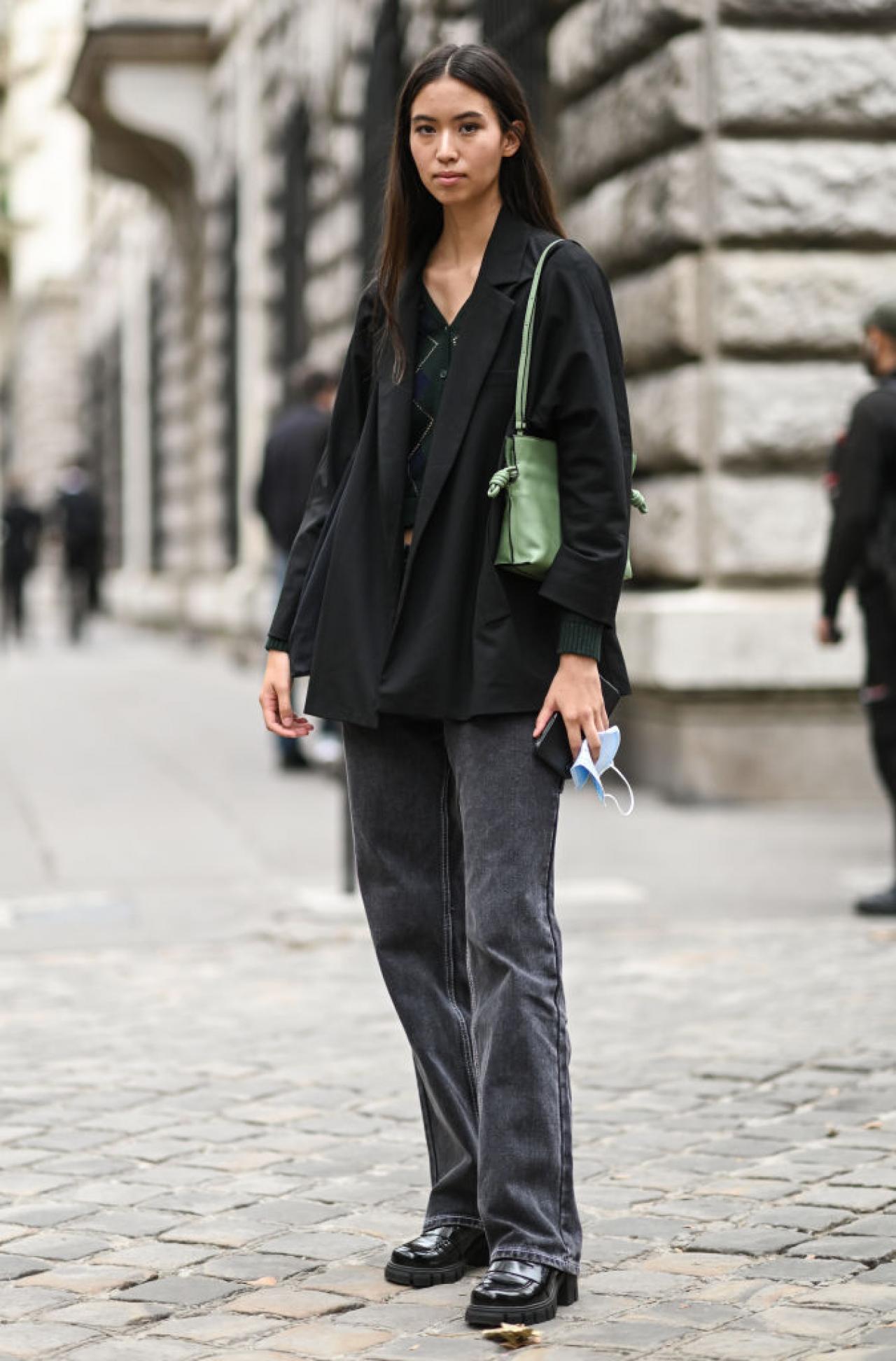 PARIS, FRANCE - OCTOBER 01: Model Cassady Smith is seen wearing a black jacket, green sweater, gray jeans with green bag outside the Loewe show during Paris Fashion Week S/S 2022 on October 01, 2021 in Paris, France. (Photo by Daniel Zuchnik/Getty Images)