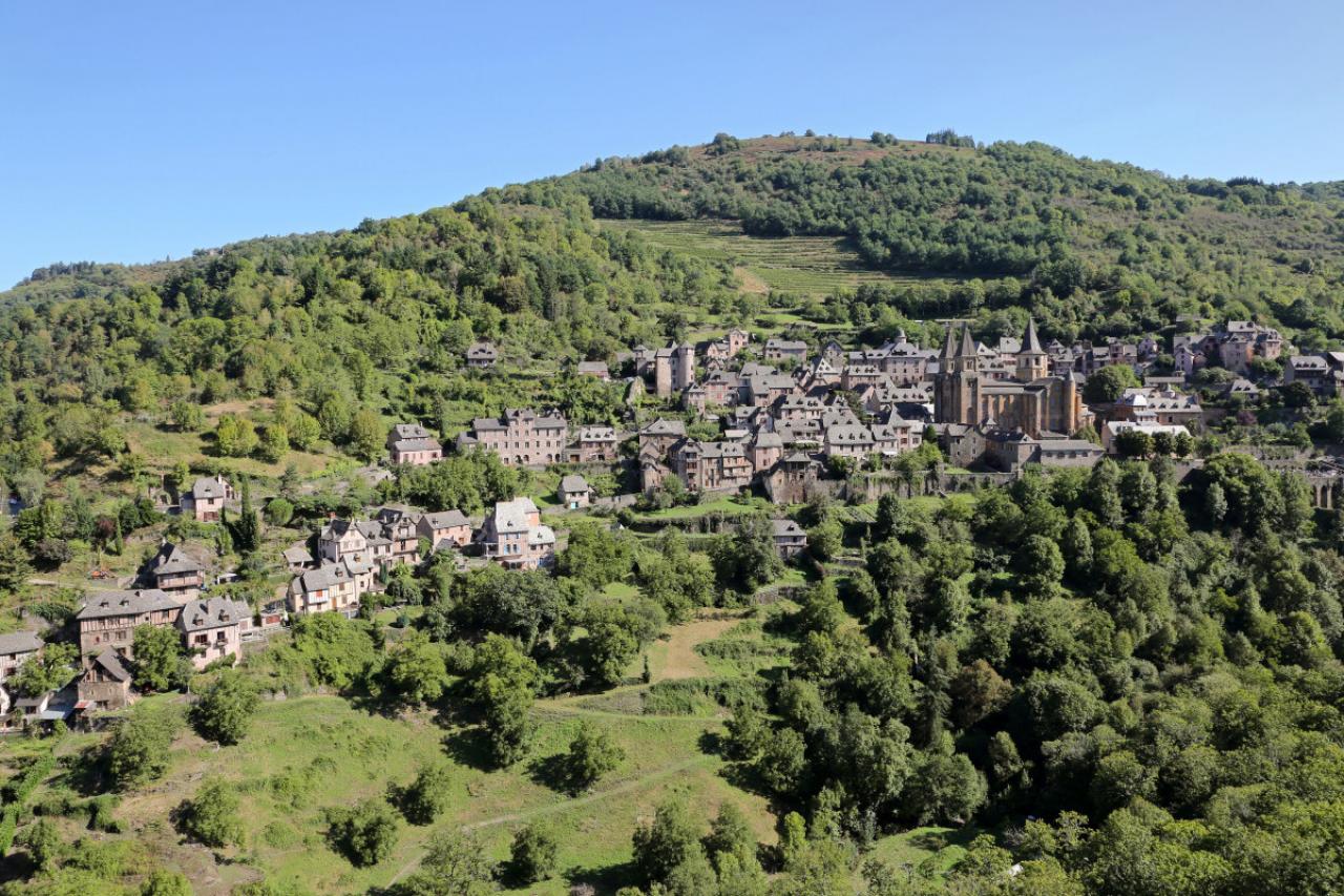 The village of Conques (south of France), in the Aveyron department, on the Way of St James (Santiago de Compostela), voie du Puy or via Podiensis pilgrimage route, France. The Abbey Church of Sainte-Foy is registered as a UNESCO World Heritage Site, Route of Santiago de Compostela in France. (Photo by: Morel J/Andia/Universal Images Group via Getty Images)