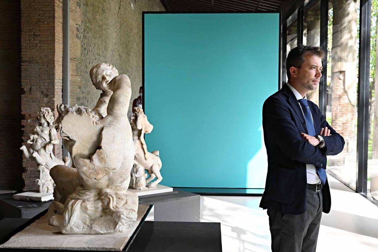 Pompeii's site director Gabriel Zuchtriegel, poses during a new exhibition in Pompeii's site entitled "Art and sensuality in the houses of Pompeii" on art and sexuality in the ancient city, where sculptures and paintings of breasts and buttocks abounded, on April 28, 2022. - Raunchy scenes may redden faces at a new exhibition in Pompeii on art and sexuality in the ancient Roman city, where sculptures and paintings of breasts and buttocks abounded. Archaeologists excavating the city, which was destroyed by the eruption of nearby Vesuvius in 79 AD, were initially startled to discover erotic images everywhere, from garden statues to ceiling frescos. (Photo by Andreas SOLARO / AFP)