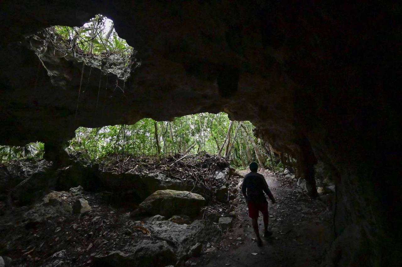 Spanish speleologist and diver Vicente Fito, 48, explores the cave system known as Garra de Jaguar (Jaguar's Claw), near the construction site of Section 5 South of the Mayan Train between the resorts of Playa del Carmen and Tulum which was halted by a district judge pending resolution of an injunction sought by scuba divers and environmentalists -- in the jungle in Playa del Carmen, Quintana Roo State, Mexico, on April 26, 2022. - A Mexican judge earlier this month suspended construction of part of President Andres Manuel Lopez Obrador's flagship tourist train project in the Yucatan peninsula due to a lack of environmental impact studies. The Mayan Train, a roughly 1,500-kilometre (950 mile) rail loop linking popular Caribbean beach resorts and archeological ruins, has met with opposition from environmentalists and indigenous communities. (Photo by Pedro PARDO / AFP)