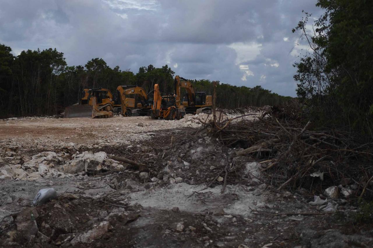 Heavy machinery remains parked at the construction site of Section 5 South of the Mayan Train between the resorts of Playa del Carmen and Tulum which was halted by a district judge pending resolution of an injunction sought by scuba divers and environmentalists -- in Playa del Carmen, Quintana Roo State, Mexico, on April 26, 2022. - A Mexican judge earlier this month suspended construction of part of President Andres Manuel Lopez Obrador's flagship tourist train project in the Yucatan peninsula due to a lack of environmental impact studies. The Mayan Train, a roughly 1,500-kilometre (950 mile) rail loop linking popular Caribbean beach resorts and archeological ruins, has met with opposition from environmentalists and indigenous communities. (Photo by Pedro PARDO / AFP)