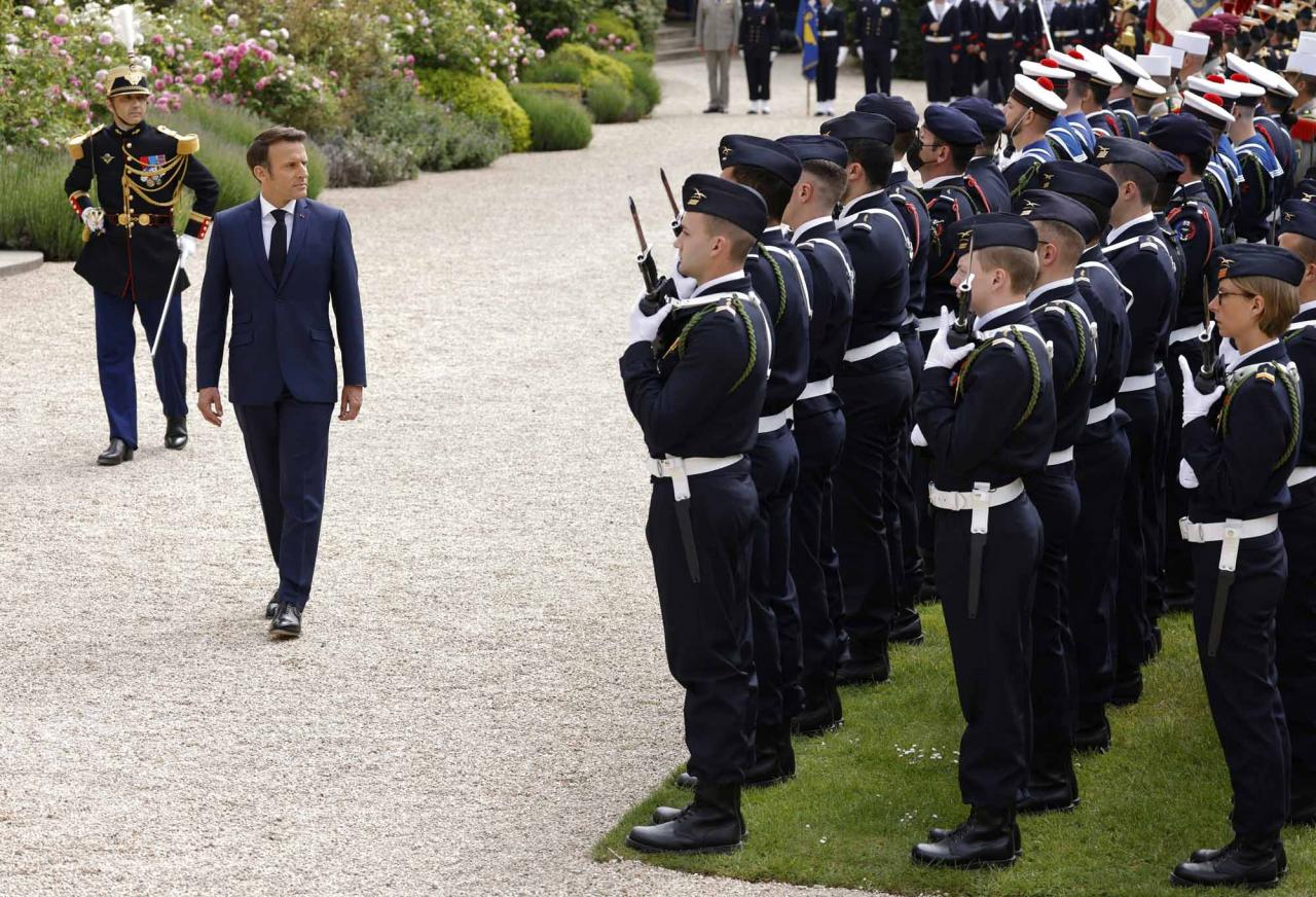 Emmanuel Macron (2L) reviews troops at the Elysee presidential palace in Paris on May 7, 2022, during his investiture ceremony as French President, following his re-election last April 24. (Photo by Ludovic MARIN / AFP)