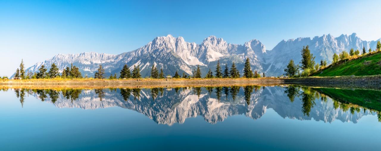 Wilder Kaiser mountain range reflecting in a lake