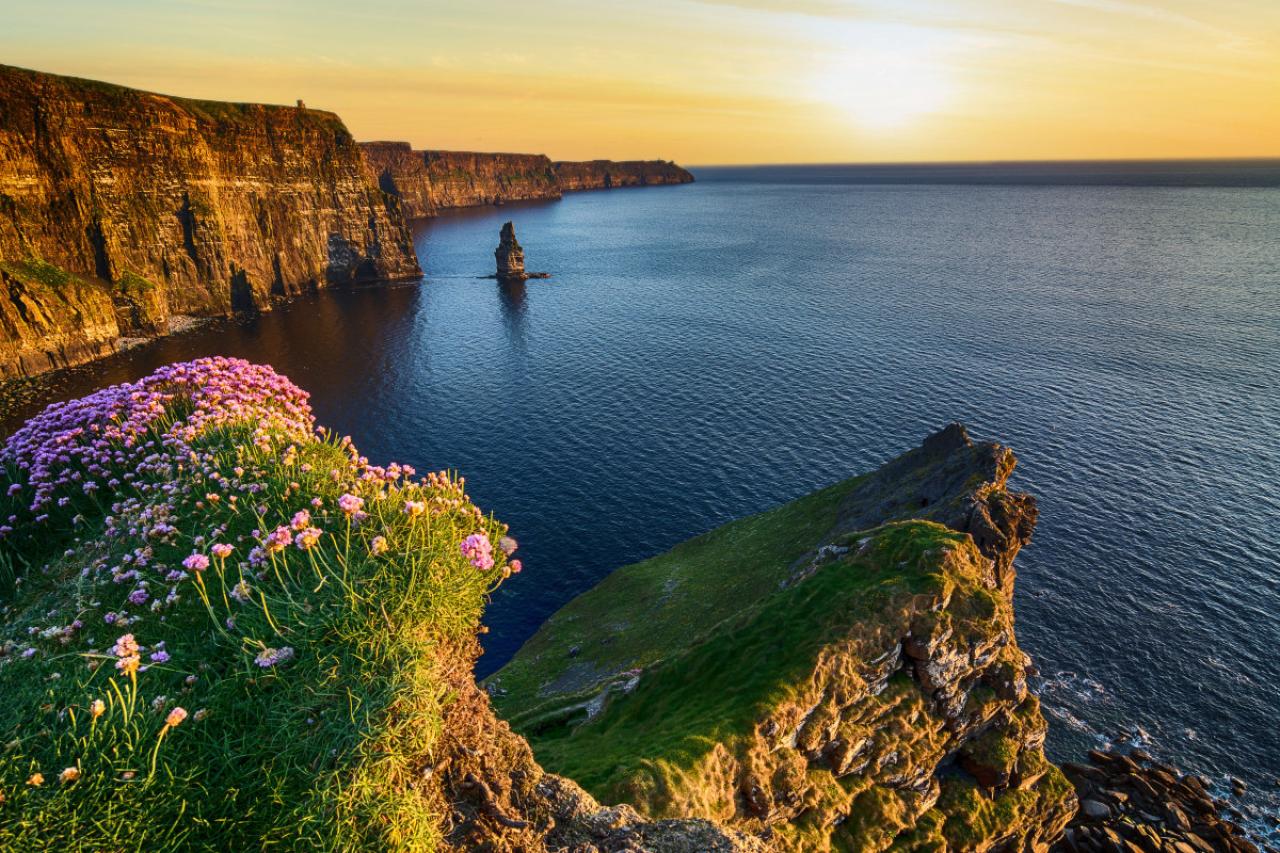 epic sunset at the cliffs of moher in county clare, ireland. beautiful evening scenic view from the wild atlantic way