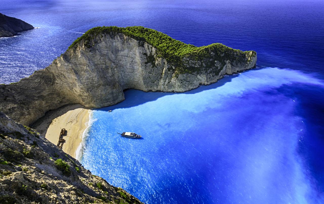 Famous Navagio beach (Smugglers Cove) with abandoned smuggler ship. Zakynthos island, Greece. ProPhoto RGB color space.