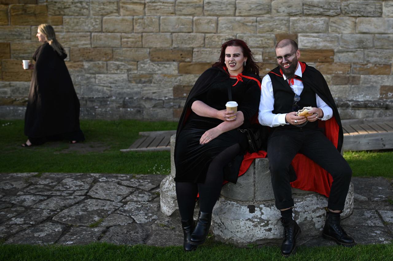 Vampires pose for a photograph in the grounds of Whitby Abbey during a Guinness world record attempt to gather the largest number of vampires together in one place, in Whitby, north-east England on May 26, 2022. - The world record attempt takes place on the 125th anniversary of the first publication of Bram Stoker's novel 'Dracula'. Stoker visited Whitby in 1890 and it's understood that the town and 13th century gothic ruins of the Abbey provided inspiration for Dracula. The current record saw 1039 vampires gather at Doswell in Virginia, USA in 2011. (Photo by Oli SCARFF / AFP)
