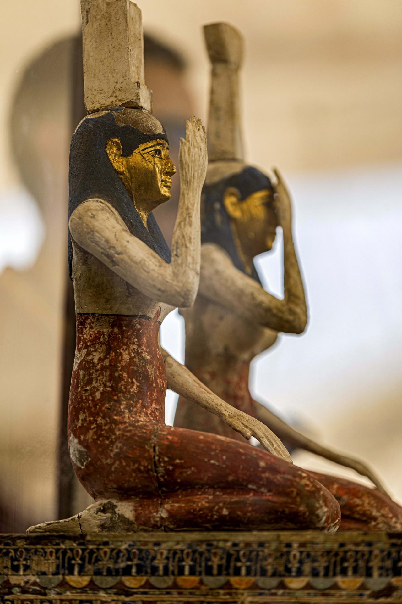 Statuettes depicting the Egyptian goddesses (L to R) Isis (Iset) and Nephthys (Nebet-Het) found in a cache dating to the Egyptian Late Period (around the fifth century BC) are displayed after their discovery by a mission headed by Egypt's Supreme Council of Antiquities, at the Bubastian cemetery at the Saqqara necropolis, southwest of Egypt's capital on May 30, 2022. - Egypt on May 30 unveiled a cache of 150 bronze statues depicting various gods and goddesses including "Bastet, Anubis, Osiris, Amunmeen, Isis, Nefertum and Hathor," along with 250 sarcophagi at the Saqqara archaeological site south of Cairo, the latest in a series of discoveries in the area. (Photo by Khaled DESOUKI / AFP)